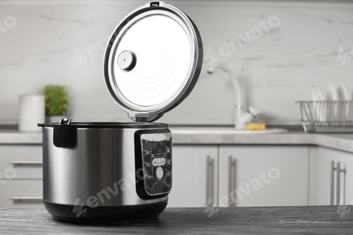 Preview: Modern multi cooker on table in kitchen. Space for text