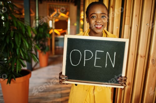 Preview: African american woman hold open welcome sign board
