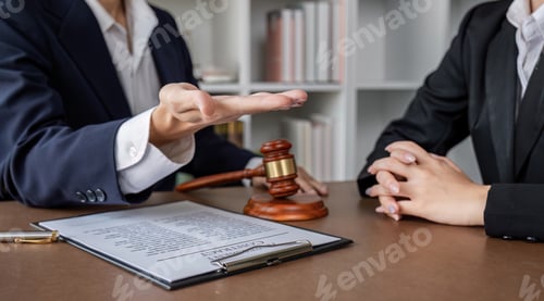 Preview: Businessman and lawyer discussing business contract document for legal advice in lawyer's office.