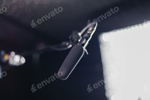 Preview: Professional microphone with a foam windscreen mounted on a boom arm, in the recording studio