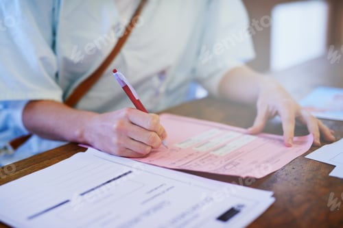 Preview: Important patient paperwork. Cropped shot of a doctor filling out paperwork in a hospital.