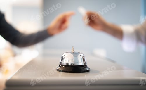 Preview: Call Bell Standing On Counter At Hotel, Receptionist Giving Key