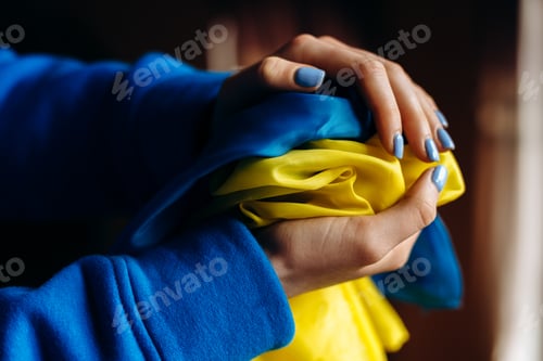 Preview: Flag of Ukraine is at the hands of the woman with nails painted at the blue and yellow colours