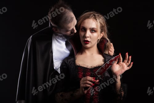 Preview: Portrait of a beautiful couple in medieval costumes with vampire style make-up for halloween