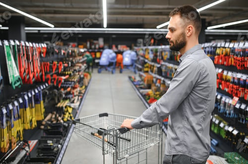 Preview: Portrait of happy mature man standing in hardware store