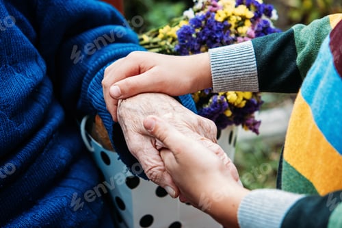 Preview: Young hands holding old elderly senior hands. Support for the seniors concept