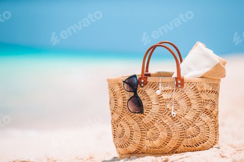 Preview: Beach accessories - straw bag, hat and unglasses on the beach
