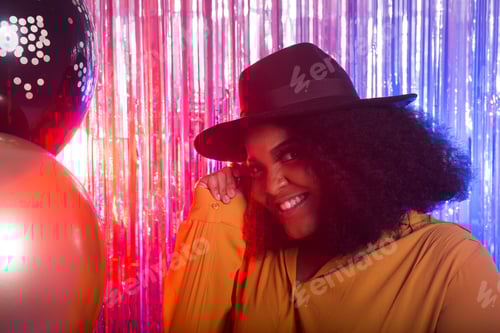 Preview: Portrait of a beautiful african american woman against twinkling background. Birthday party