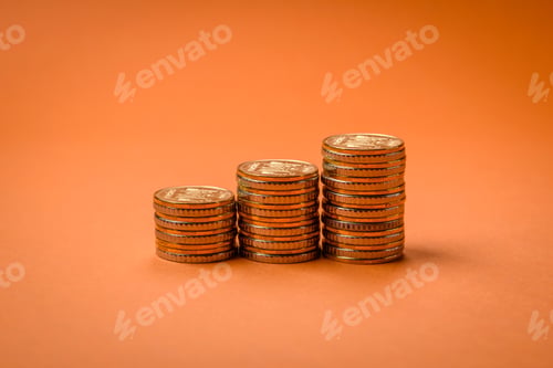Preview: Round metal yellow coins folded in the form of columns on a plain colored background