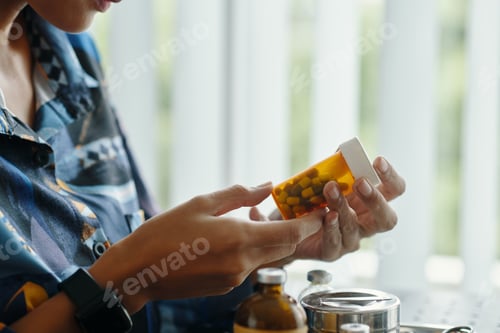 Preview: Woman Reading Information About Pills