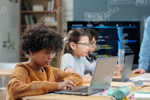 Focused Children Learning Coding Skills at School
