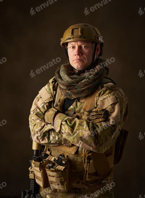 Preview: portrait of an airsoft soldier in camouflage clothing with arms crossed