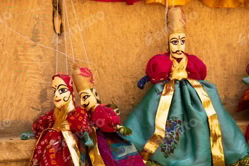 Preview: Colorful Rajasthani puppets hanging in the street of Jaisalmer, India.