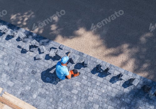 Preview: Skilled Worker Laying Pavers in a Sunny Outdoor Space