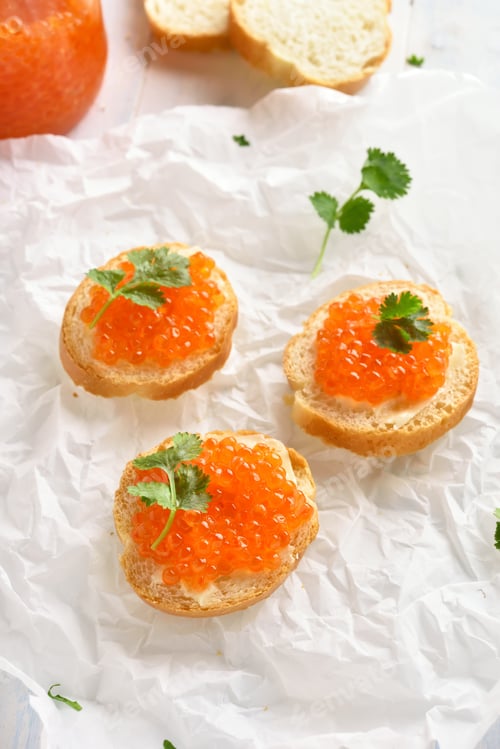 Preview: Delicious Appetizers with Orange Caviar on White Background