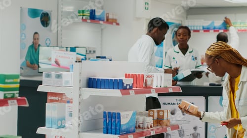 Preview: African american woman looking at medicine on racks