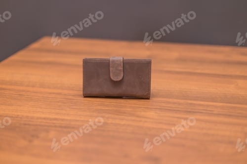 Preview: Brown leather wallet on the wooden table
