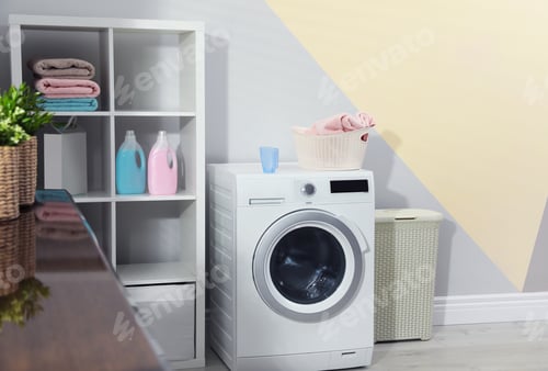 Preview: Modern washing machine in laundry room interior