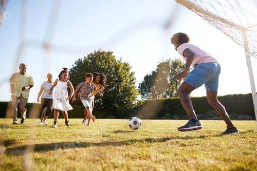 Preview: Kids approach dad in goal during family football game