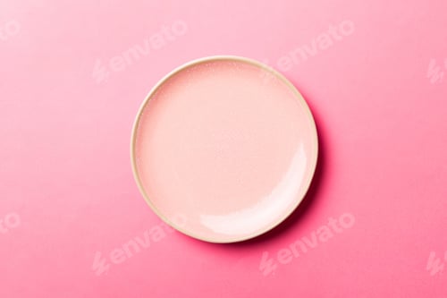 Preview: Top view of isolated of colored background empty round pink plate for food.