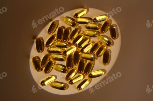 Preview: Omega 3 fish oil capsules scattered on surface