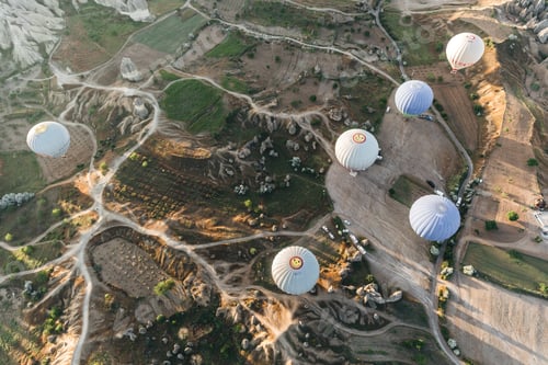 Preview: CAPPADOCIA, TURKEY - 09 MAY, 2018: top view of hot air balloons flying above famous goreme national