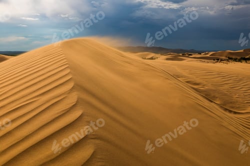 Preview: Storm clouds over sand dunes in the desert