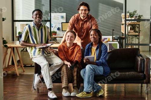 Preview: Four young interracial employees or creative designers in casualwear