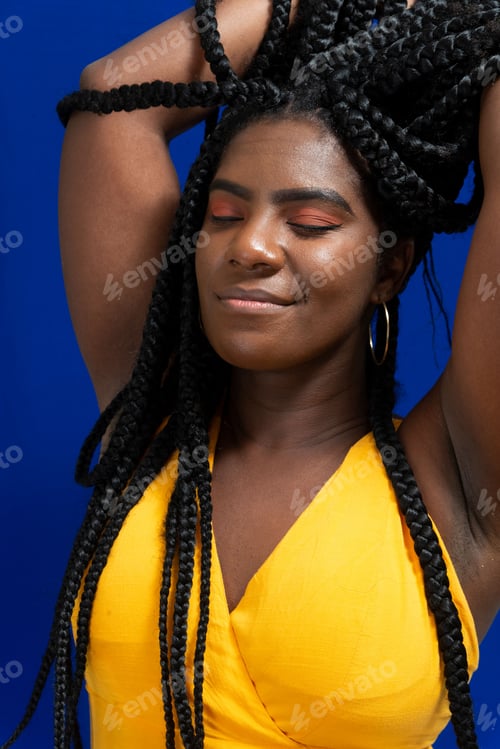 Preview: Young woman wearing colorful long clothes over blue background.