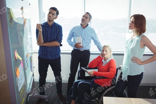 Preview: Thoughtful business entrepreneurs looking at whiteboard