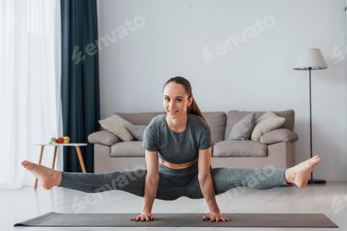 Preview: Exercises for stamina. Young woman with slim body type and in yoga clothes is at home