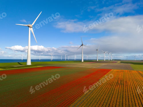 Preview: offshore windmill park with clouds and a blue sky, windmill park in the ocean drone aerial view with