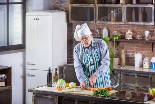 Preview: Senior Man Preparing Fresh Vegetables in Kitchen