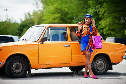 Preview: African american lady near orange classic retro car