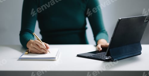 Preview: businesswoman hand working with new modern computer and writing on the notepad strategy diagram