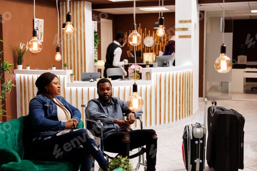 Preview: Disabled man with wife in hotel lobby