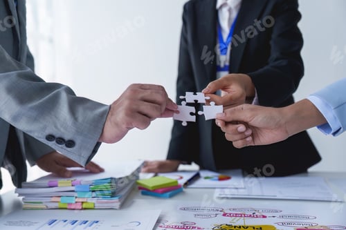 Preview: Group of business people putting their hands working together on wooden background in office. group