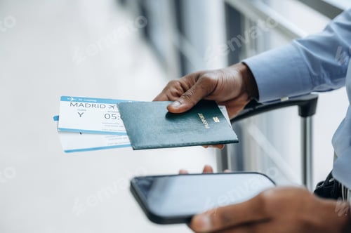 Preview: Phone and tickets in hands. Male tourist is in the airport corridor