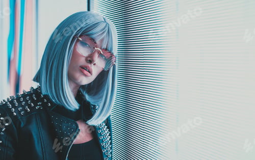 Preview: Image of a beautiful young woman posing against a led panel.