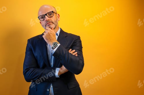 Preview: A man with a beard and a blue suit is thinking