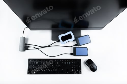 Preview: Multiple external hard drives connected to a monoblock on a white background.Computer with hard