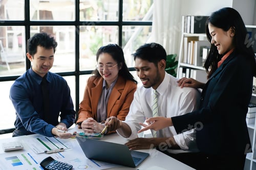Preview: Two women and two men in a business meeting, Diverse business people laughing during a meeting