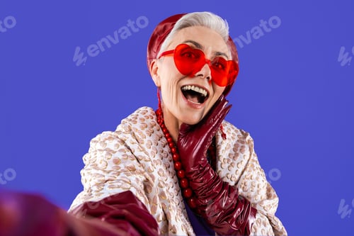Preview: Happy and funny senior old woman on colorful background
