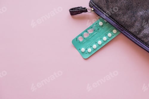 Preview: blister with oral contraceptives on pink background with free space for text