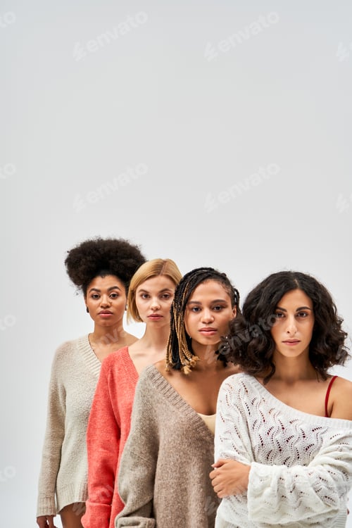 Preview: Multiethnic women in warm knitted sweaters looking at camera