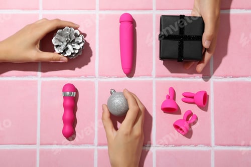 Preview: Sex toys with Christmas gifts on the background.