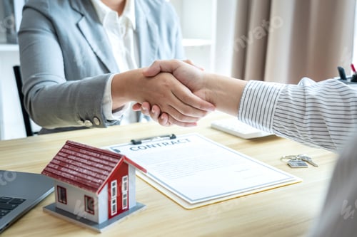 Preview: Estate agent and customers shaking hands together celebrating finished contract after signing