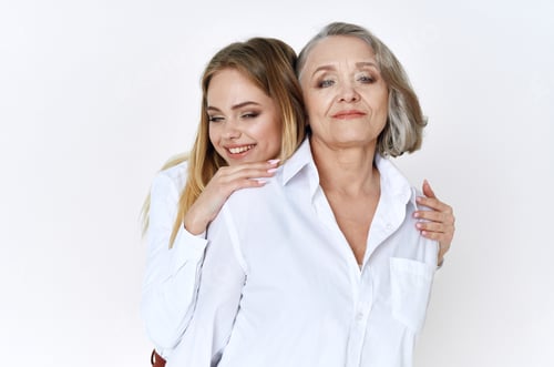 Preview: cheerful mom and daughter in white shirts embrace lifestyle