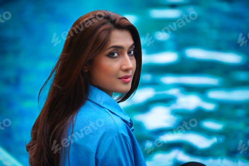 Preview: Portrait of beautiful model near the pool