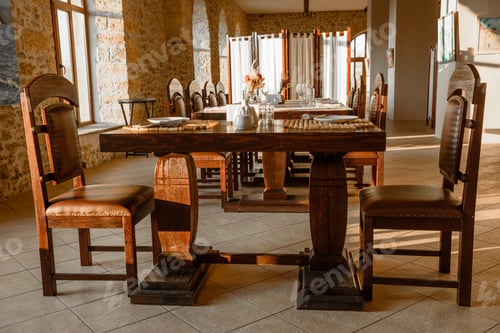Preview: Glasses, flower fork, knife served for dinner in restaurant with cozy interior